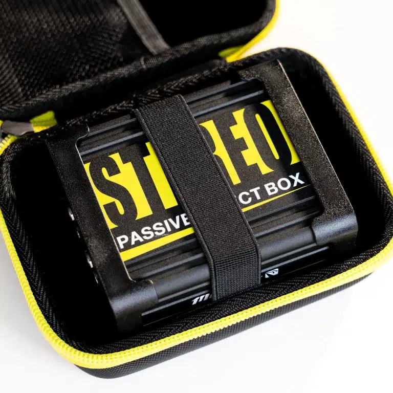 Close-up of a black electronic device secured inside a case with a yellow zipper and Velcro strap, visible text includes 'PASSIVE' and 'BOX'. ขายราคาพิเศษ