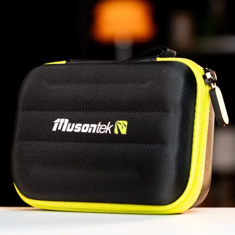 Black, textured travel case with a bright yellow zipper and handle, front logo reads Husontek I ground-level shot on a white surface after a blurred background. ขายราคาพิเศษ