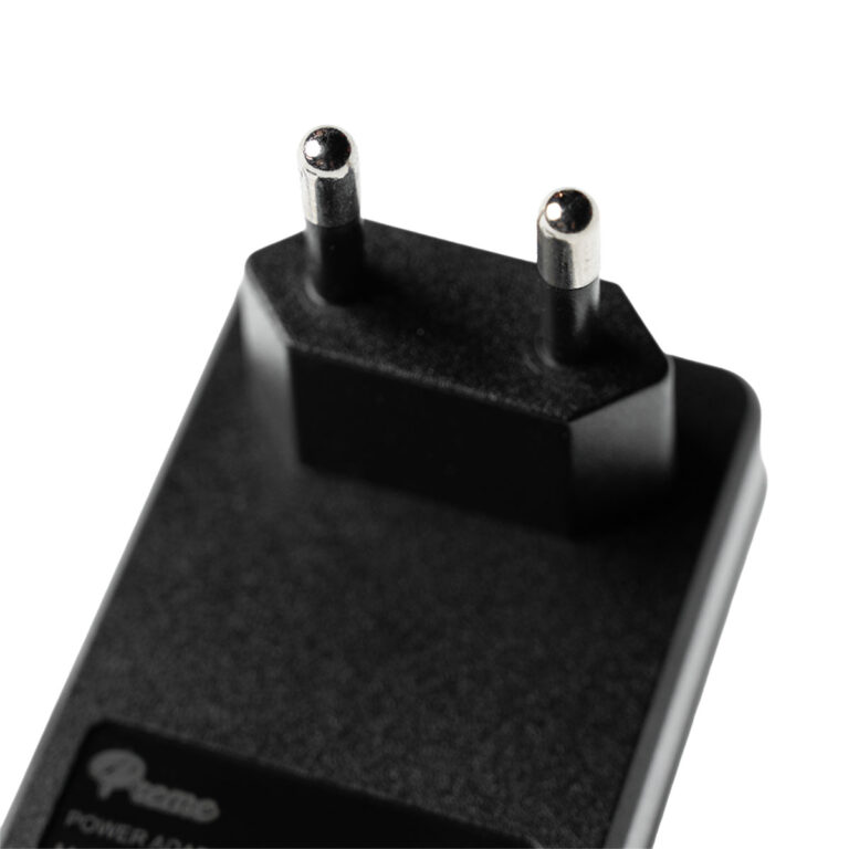 Close-up of a black power adapter with two round metal prongs on a white background, ready to plug in. ขายราคาพิเศษ