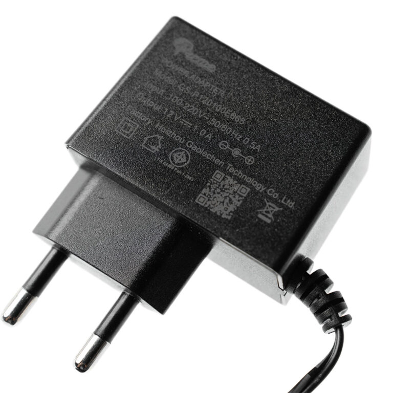 Black European-style power adapter with two round prongs and a coiled cord, close-up against a white background for device charging use. ขายราคาพิเศษ