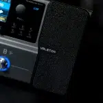 Close-up of a textured black Valeton guitar effects pedal with the brand name visible beside other control knobs and panels. ขายราคาพิเศษ