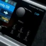 Close-up of a handheld music controller screen showing EXP, PARA, and a row of labeled buttons (BACK, EDIT, SAVE, DRUM, GLOBAL, BT). ขายราคาพิเศษ