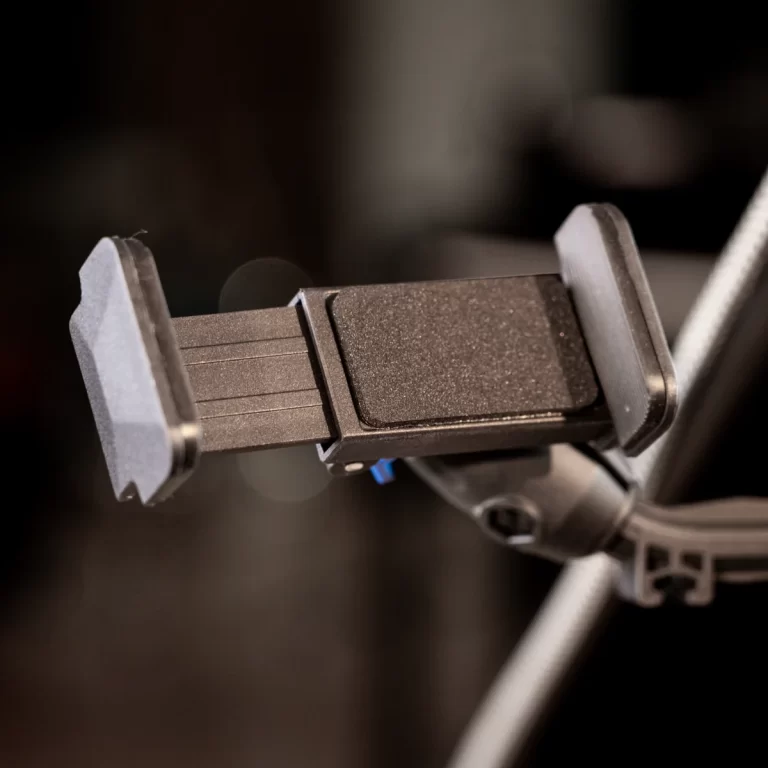 Phone holder clamp attached to a bike handlebar, with adjustable arms for a smartphone ขายราคาพิเศษ