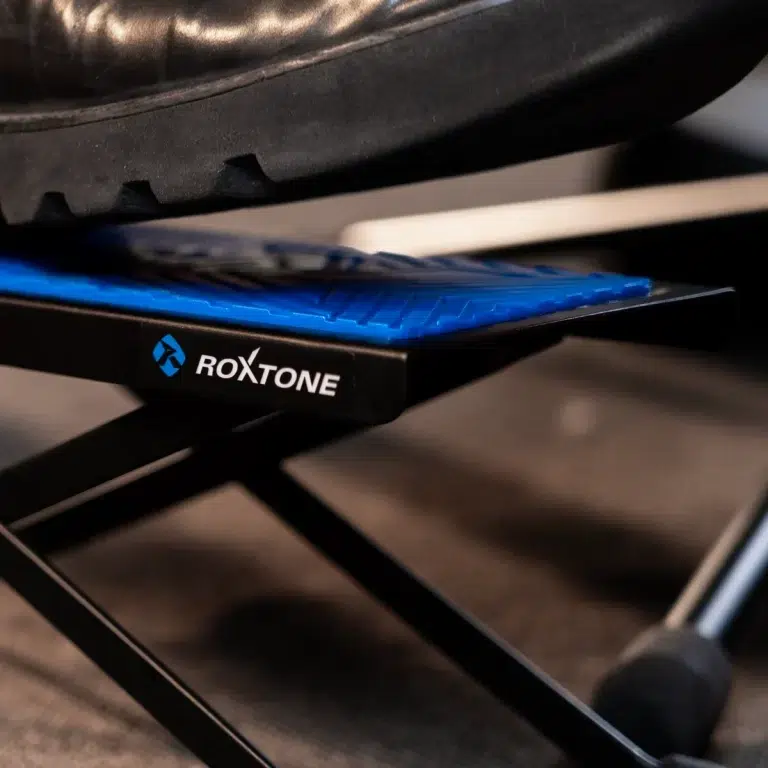 Close-up of a RoxTone blue foot pedal attached to a black stand. ขายราคาพิเศษ