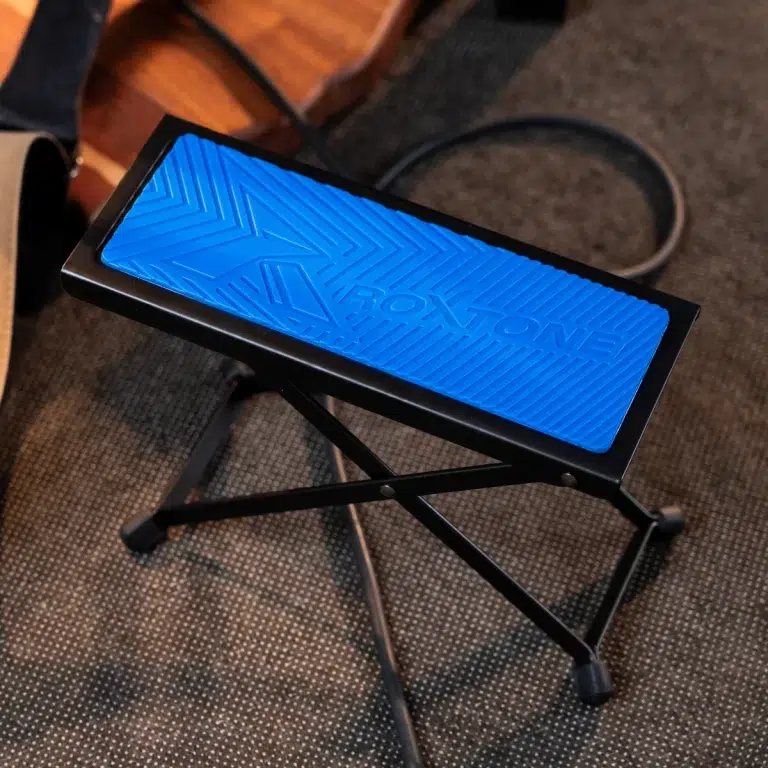 Blue textured footrest on a black folding frame resting on a carpet. ขายราคาพิเศษ