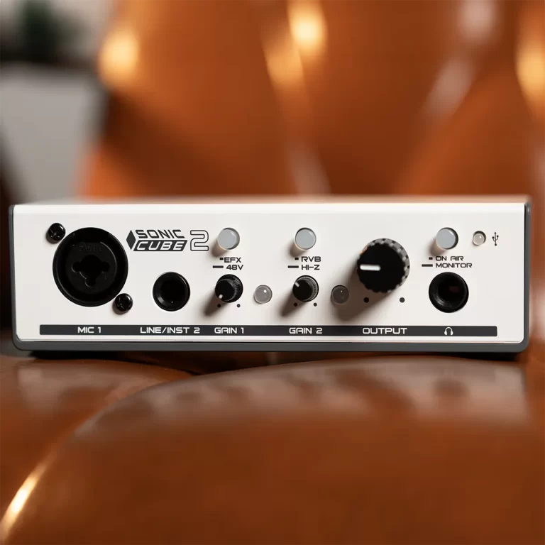 Front panel of a portable audio interface with mic input, line/instrument input, gain knobs, and master output control on a wooden surface. ขายราคาพิเศษ
