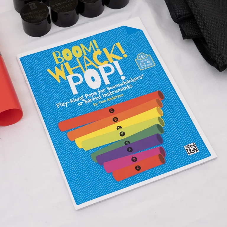 Bright blue cover of Boom Whack! Pop! children’s activity book showing rainbow Boomwhackers on a zigzag background. ขายราคาพิเศษ