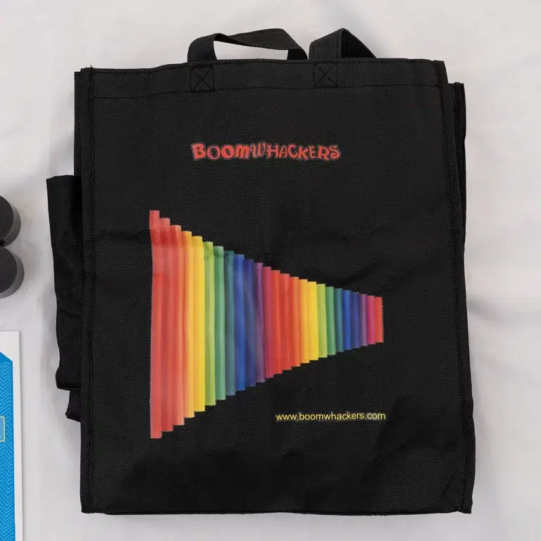Black tote bag with a colorful diagonal rainbow graphic and the Boomwhackers logo; includes www.boomwhackers.com URL at the bottom. ขายราคาพิเศษ