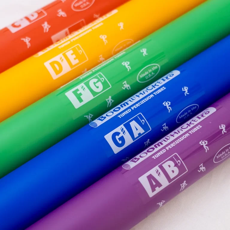 Colorful Boomwhacker tubes arranged diagonally, labeled with note pairs like D–E, F–G, A–B, in a rainbow of colors ขายราคาพิเศษ