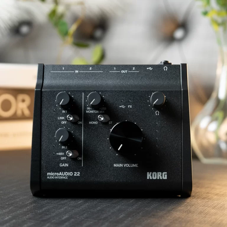 KORG microAUDIO 22 audio interface on a dark desk, front panel with gain knobs and main volume control visible. ขายราคาพิเศษ