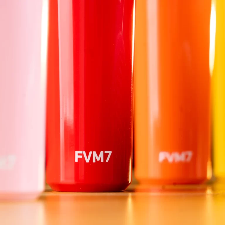 Close-up of glossy color tubes in pink, red, orange, and yellow; front red tube labeled FVM7. ขายราคาพิเศษ