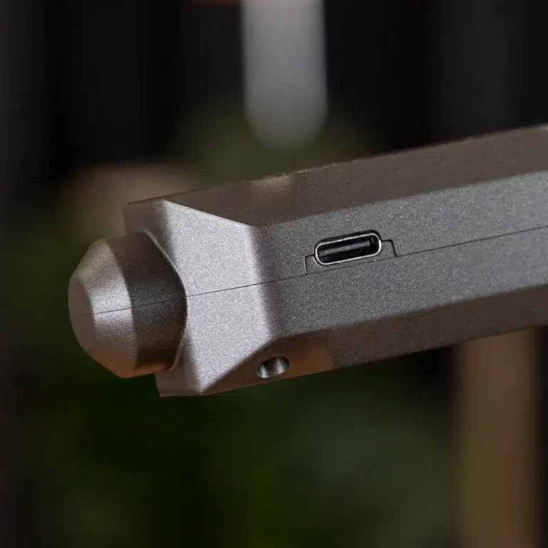 Close-up of a gray metal device showing a USB-C charging/data port on its side. ขายราคาพิเศษ