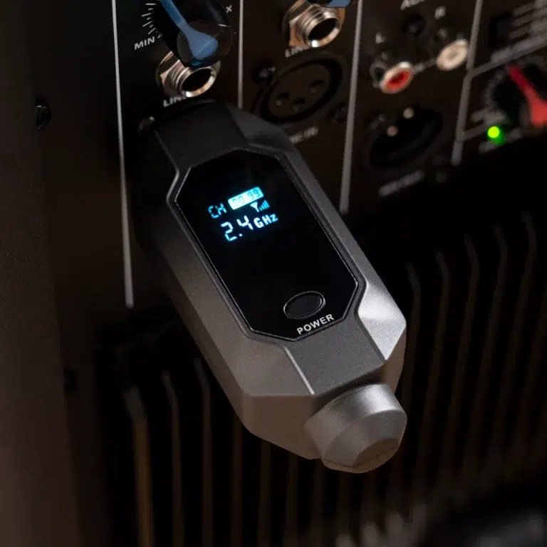Wireless mic receiver plugged into a rack, display shows channel 2.4 GHz and power button. ขายราคาพิเศษ