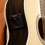 Acoustic guitar with a black Fishman Presys preamp panel mounted on the side, showing knobs labeled volume, contour, phase and small toggle switches. ขายราคาพิเศษ