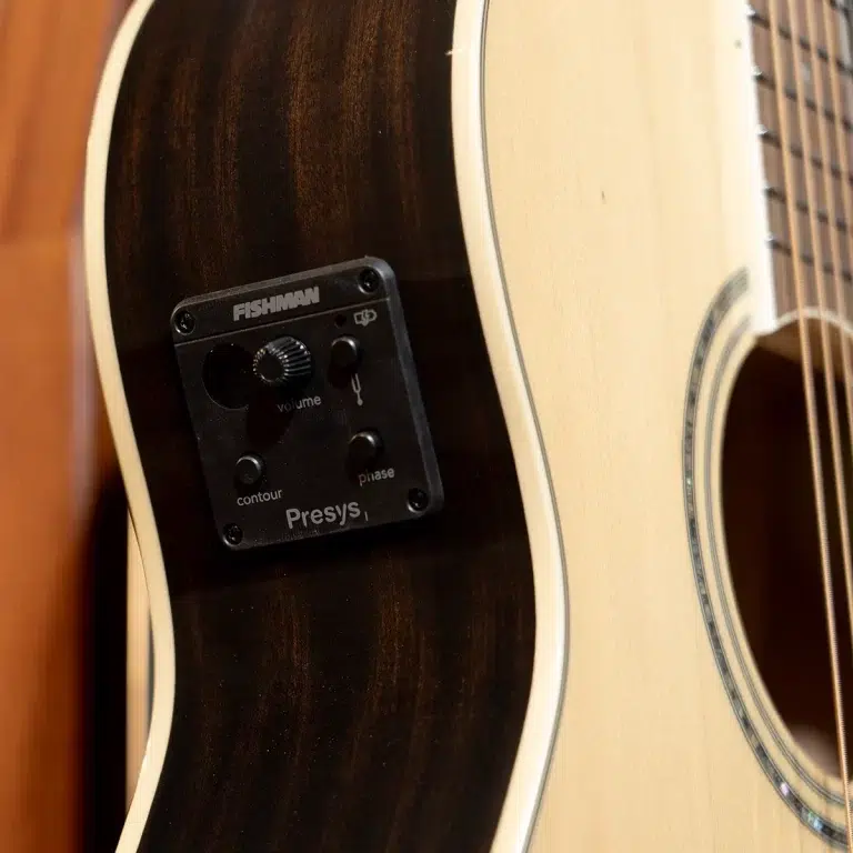 Acoustic guitar with a black Fishman Presys preamp panel mounted on the side, showing knobs labeled volume, contour, phase and small toggle switches. ขายราคาพิเศษ
