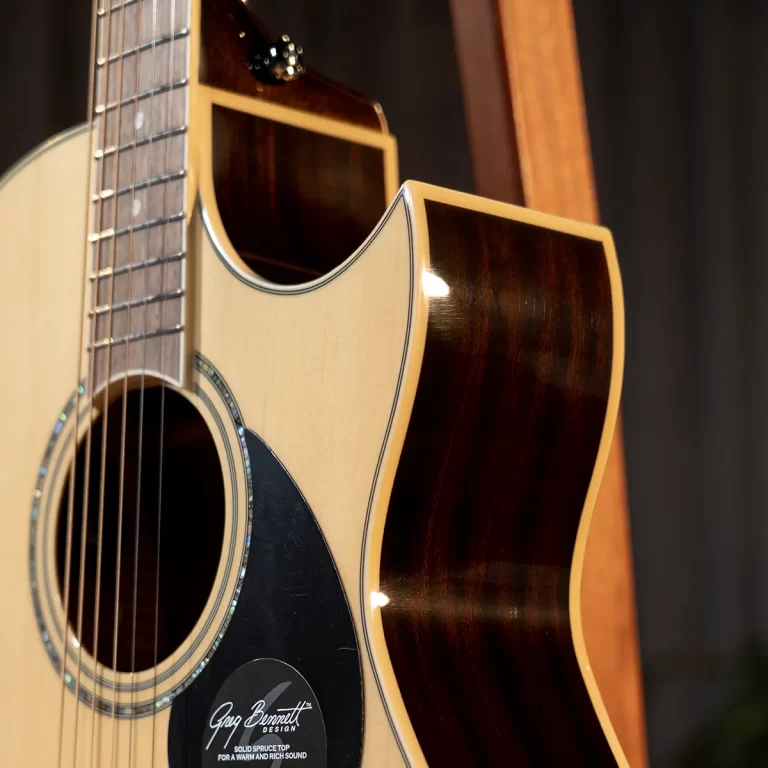 Close-up of an acoustic guitar's body with the soundhole, rosette, and six strings visible. ขายราคาพิเศษ
