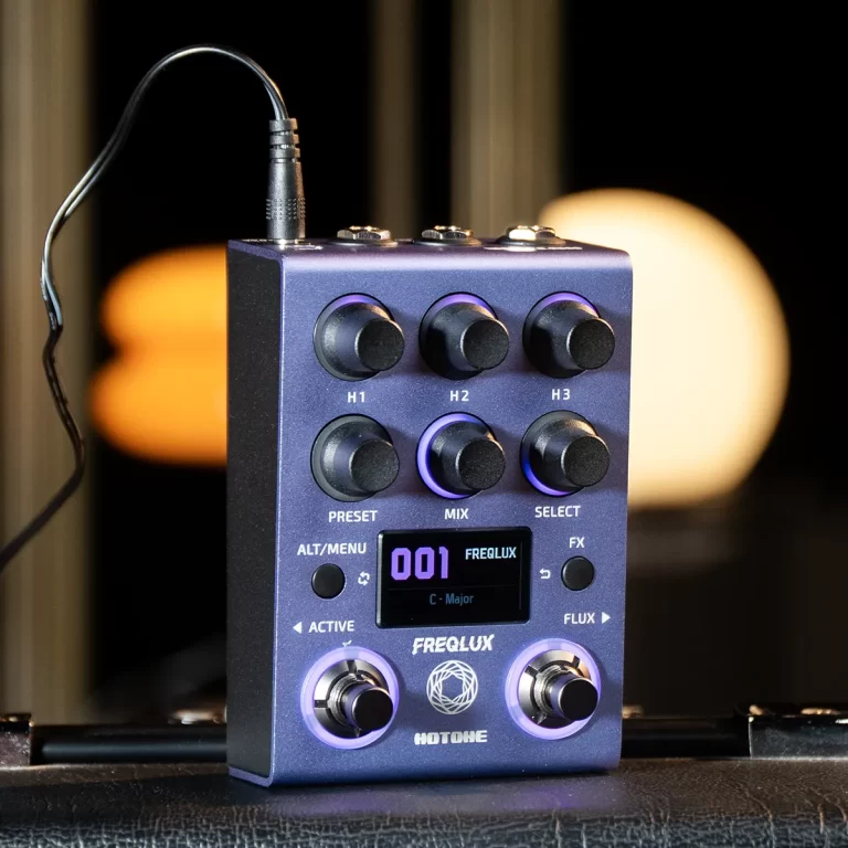 Compact guitar effects pedal with multiple knobs, small display, and purple-lit accents on a dark blue chassis. ขายราคาพิเศษ
