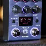 Close-up of a Hotone FREQ LUX guitar effect pedal front panel with colorful knobs, a small display, and illuminated rings around the footswitches. ขายราคาพิเศษ