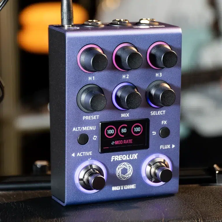Purple FreQ Lux Hotone guitar effects pedal with six knobs, a small LCD display, and two glowing footswitches (H1/H2/H3, PRESET, MIX, SELECT). ขายราคาพิเศษ