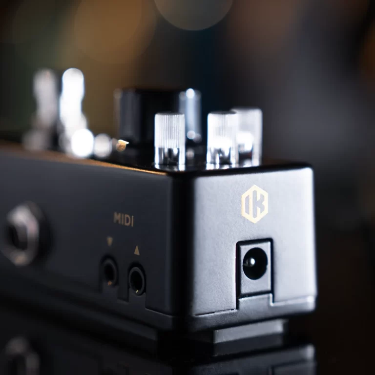 Close-up of a music hardware module with knobs on top, a MIDI label on the side, and a power jack on the front. ขายราคาพิเศษ