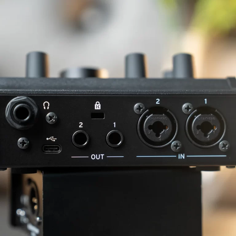 Rear view of an audio interface showing input/output panel, USB-C port, and two XLR/TRS combo jacks labeled OUT and IN among control knobs and connectors. ขายราคาพิเศษ