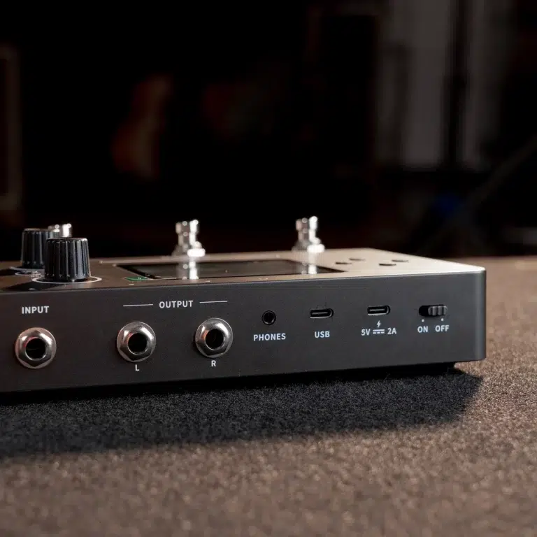 Audio interface front panel showing input, left/right outputs, headphone jack, USB and power switch on a dark desk surface. ขายราคาพิเศษ