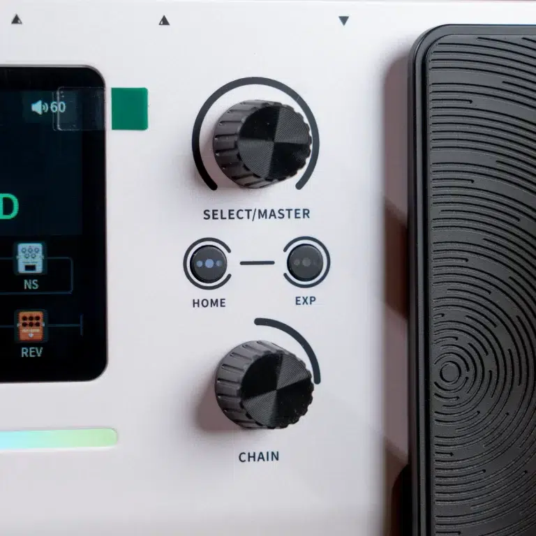 Close-up of a music/effects unit's control panel showing the SELECT/MASTER knob, HOME and EXP buttons, and the CHAIN knob. ขายราคาพิเศษ