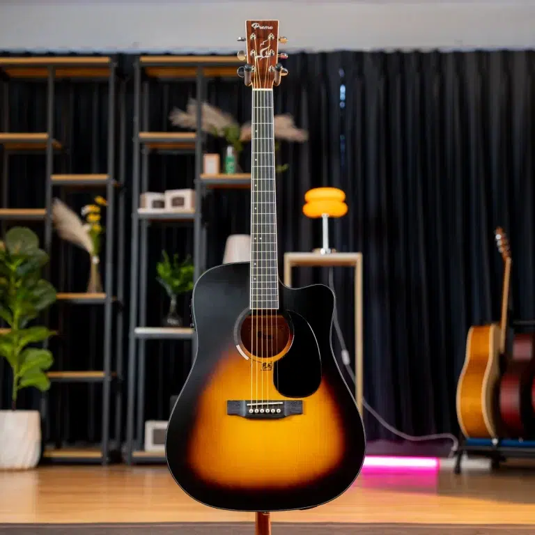 Sunburst acoustic guitar on a stand in a music showroom with other guitars and shelves in the background. ขายราคาพิเศษ