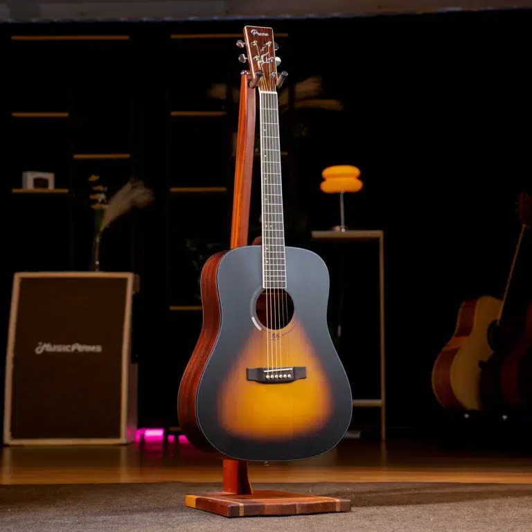 Sunburst acoustic guitar on a wooden stand on a dim stage with amplifiers in the background. ขายราคาพิเศษ