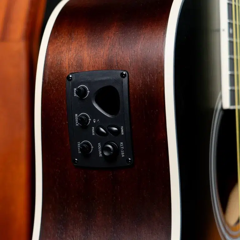 Close-up of a brown acoustic guitar body with a black pickup control panel featuring Bass, Middle, Treble, and Volume knobs. ขายราคาพิเศษ