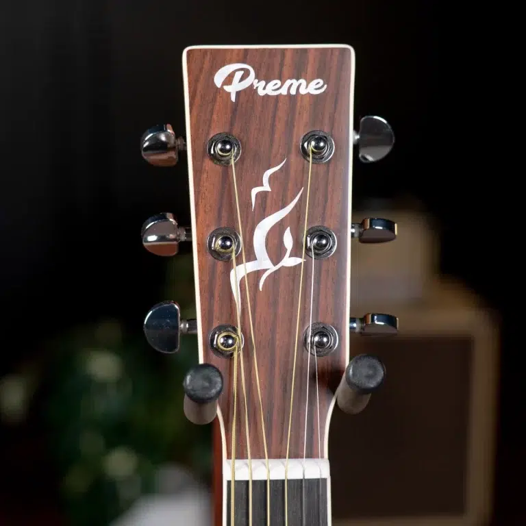 Guitar headstock with wood grain finish and six tuning pegs, logo reads 'Preme' at top center. ขายราคาพิเศษ
