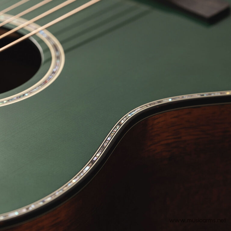 Close-up of a green guitar body showing the soundhole, rosette, and fretboard edge with strings crossing diagonally. ขายราคาพิเศษ