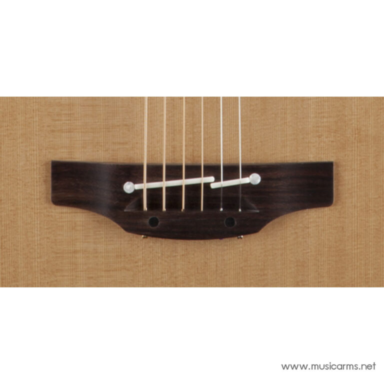 Close-up of a classical guitar bridge showing six strings anchored in the dark wooden bridge plate on a light wood topood, nylon strings visible. ขายราคาพิเศษ