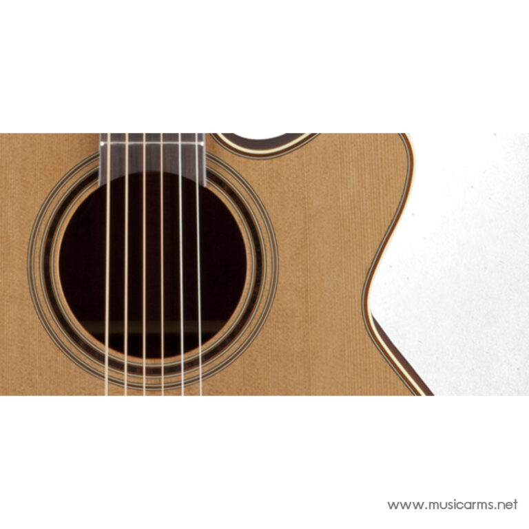 Close-up of an acoustic guitar's wooden body, showing the soundhole and six strings traversing the neck area. ขายราคาพิเศษ