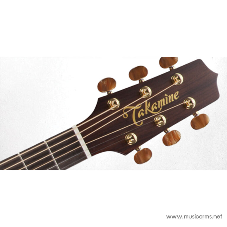 Close-up of a Takamine guitar headstock with gold tuning pegs on dark wood surface. ขายราคาพิเศษ