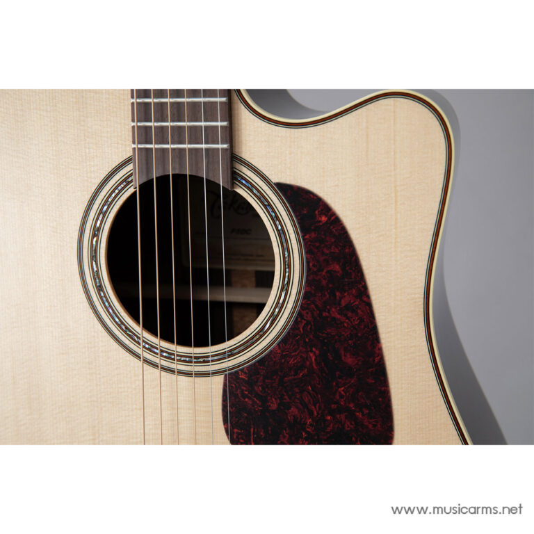 Close-up of an acoustic guitar body showing sound hole, rosette, and strings with a dark tortoiseshell pickguard; watermark www.musicarms.net is visible. ขายราคาพิเศษ