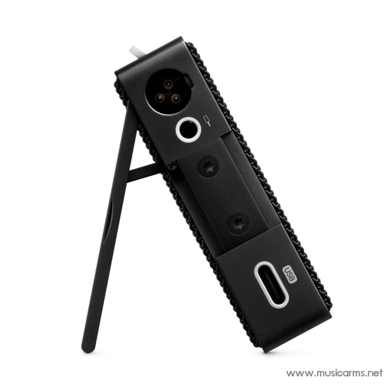 Close-up of a black portable audio interface with a USB-C port and a circular input jack, mounted on a stand or clip. ขายราคาพิเศษ