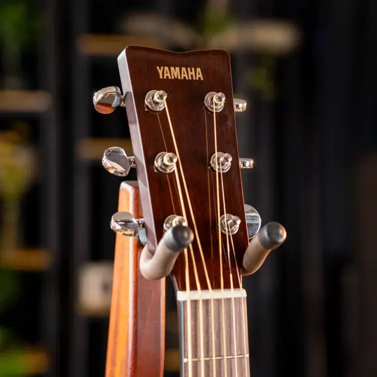 Close-up of a Yamaha acoustic guitar headstock with six tuning pegs and strings ขายราคาพิเศษ