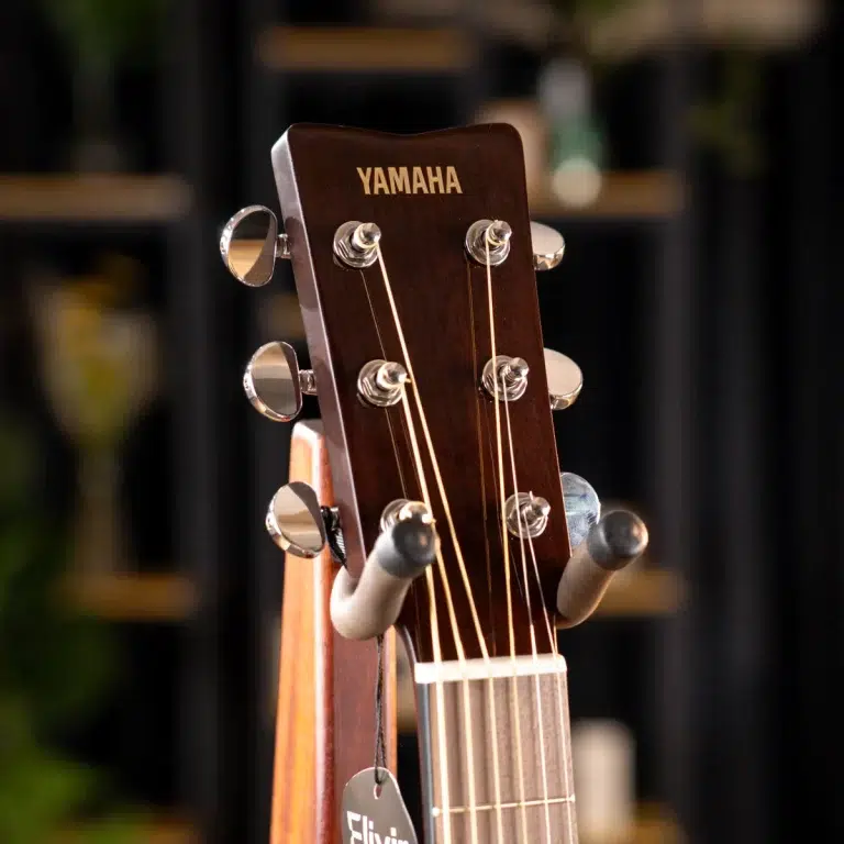 Close-up of a Yamaha acoustic guitar headstock with six tuning pegs and strings ขายราคาพิเศษ