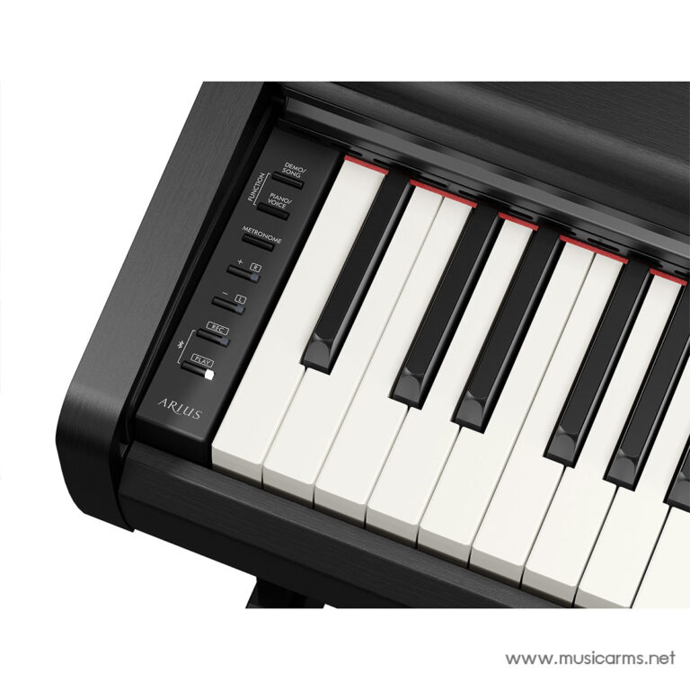 Close-up of a black digital piano keyboard viewed from the side, showing white keys, the control panel on the left, and the Arius brand with a www.musicarms.net watermark. ขายราคาพิเศษ