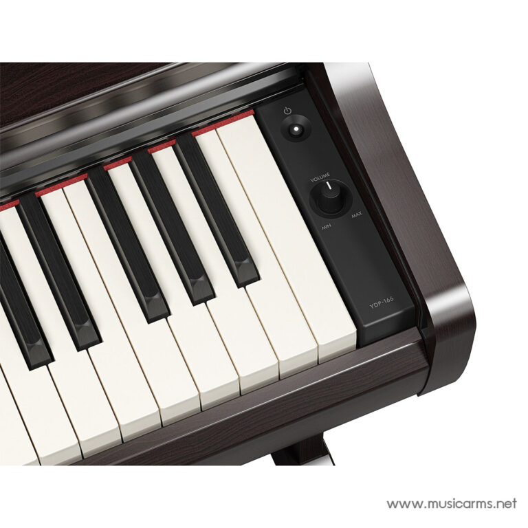 Close-up of a wooden upright piano keyboard with black and white keys and a dark side panel featuring a volume knob and power button on the right. ขายราคาพิเศษ