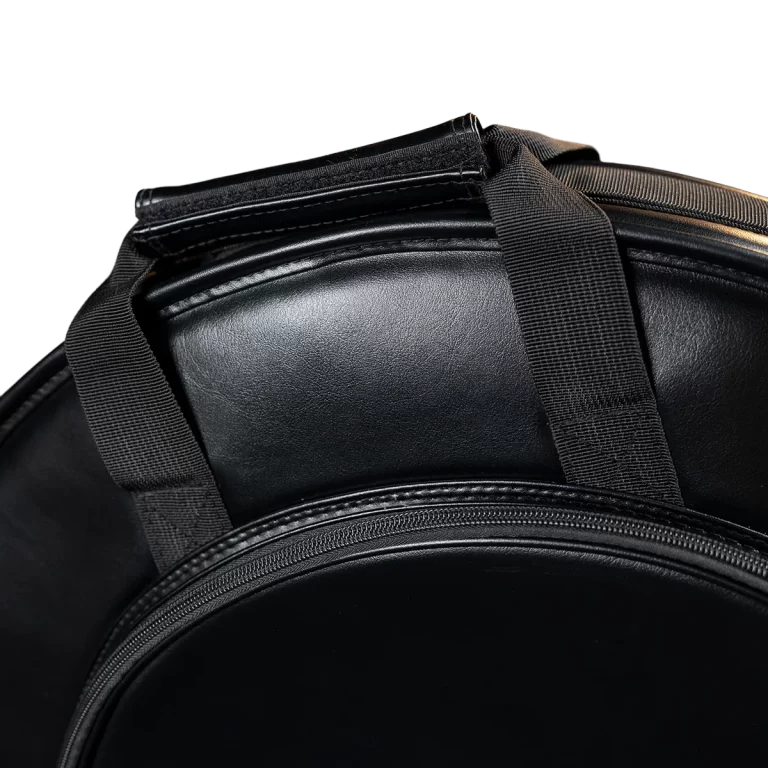Close-up of a black leather bag with stitched straps and a zipper pocket in the foreground. ขายราคาพิเศษ