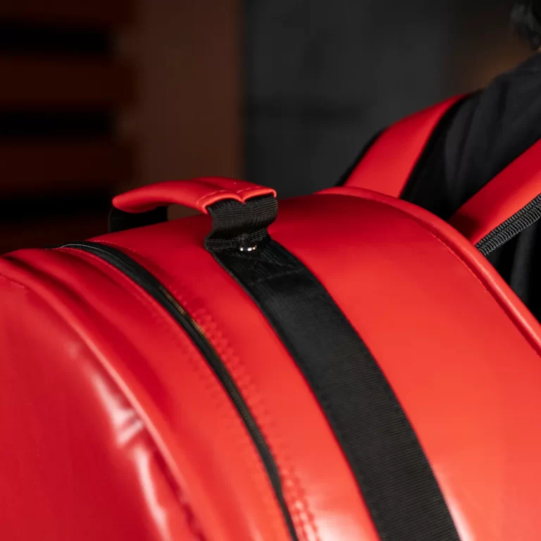 Close-up of a bright red life jacket with a black adjustable strap and stitching detail. ขายราคาพิเศษ