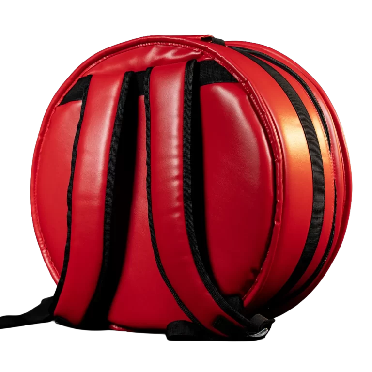 Red circular backpack with black padded shoulder straps, shown from the side on a dark background. ขายราคาพิเศษ