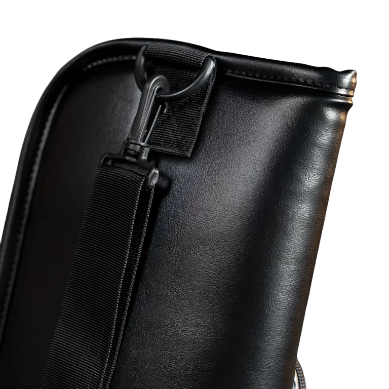 Close-up of a black leather bag showing a detachable shoulder strap clipped to a metal ring on the bag edge as a functional detail. ขายราคาพิเศษ