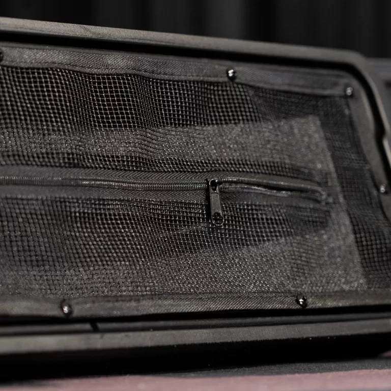 Close-up of a black mesh pocket with a zipper, part of a bag or suitcase. ขายราคาพิเศษ