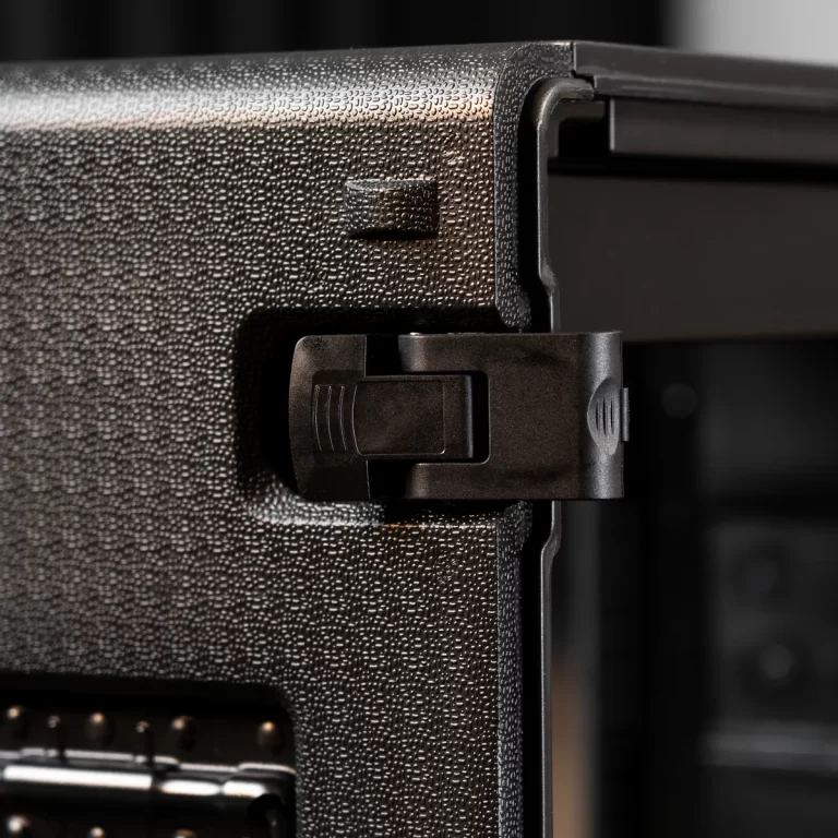 Close-up of a black plastic latch securing a rugged textured case. ขายราคาพิเศษ