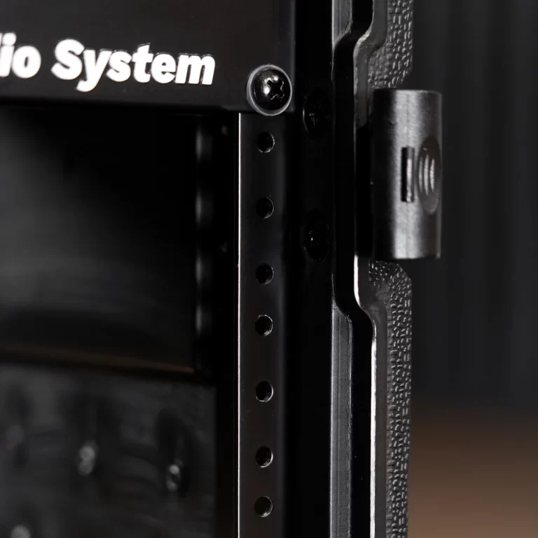Close-up of a black perforated rack rail with evenly spaced holes and a side latch on the right, part of a mounting system. ขายราคาพิเศษ