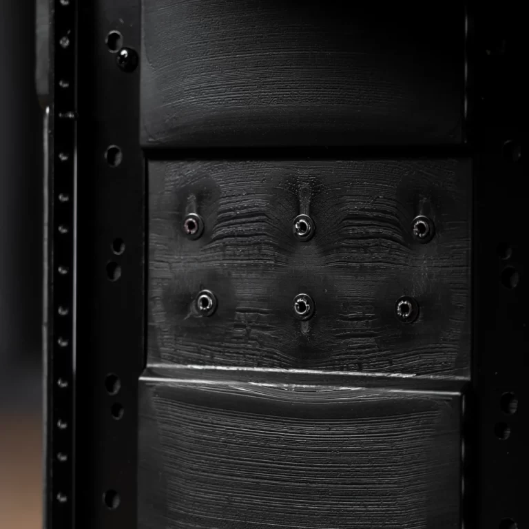 Close-up of a black metal panel with six screws and textured grain in a machine cabinet. ขายราคาพิเศษ