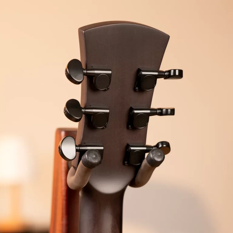Back of a guitar headstock with six black tuning pegs visible ขายราคาพิเศษ